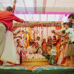 The whole family gets involved in the celebration, showering the couple with flower petals during the haldi ceremony. It's a moment of pure, collective joy.