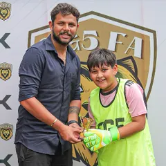 A young goalkeeper receives his Player of the Match trophy, highlighting our focus on celebrating defensive players as much as attackers.
