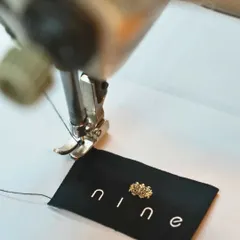 Even our brand labels are stitched with care. This small detail, featuring our crown logo, is a mark of the pride we take in our workmanship.