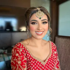 The joy on a bride's face is my greatest reward. For Jasmeet, I crafted a radiant bridal look with soft, defined eyes and a warm, glowing complexion that perfectly complemented her traditional red lehenga.