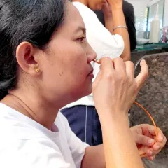 A close-up view of a practitioner learning Sutra Neti, a nasal cleansing kriya using a thread. This advanced technique is always taught under the strict supervision of our experienced instructors to ensure safety.
