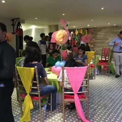 A wider view of the birthday celebration, showing the vibrant table settings and happy guests. My goal is to create a festive atmosphere where everyone, hosts included, can enjoy the party.