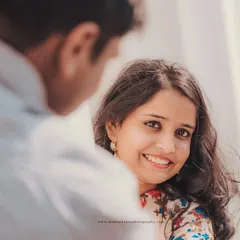 The beauty of a natural smile. This over-the-shoulder shot creates a personal and intimate feel, focusing entirely on her happy expression.