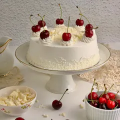 My White Forest Gateau is a delicate alternative to its darker cousin. It features layers of soft vanilla sponge, white chocolate ganache, and fresh cherries, creating a light and elegant dessert.