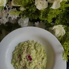 A beautifully plated dish of Wild Asparagus Risotto, garnished with parmesan and edible flowers. A creamy and elegant Italian main.