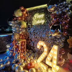 Another perspective of the glamorous 24th birthday setup. This angle highlights the large, illuminated '24' marquee numbers and the way the balloon garland frames the shimmering sequin wall and 'Happy Birthday' neon sign.