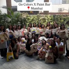 The Go Colors team in Mumbai proudly showing off the tote bags they painted. This is a great activity that results in a practical and personal souvenir.