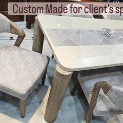Custom-made for the client's space, this image shows the detail of the open-grain finish on the chair's armrest and the smooth, modern tabletop.
