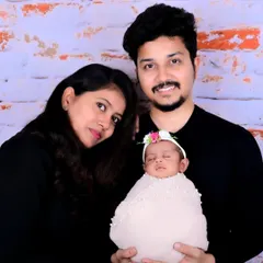 A simple and beautiful portrait of new parents with their newborn, showcasing the love and connection of a new family.