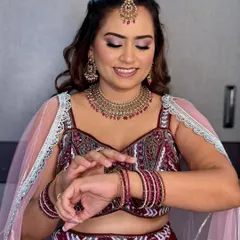 A beautiful engagement look featuring soft glam makeup with a touch of shimmer. The rosy tones on her eyes and cheeks bring out her inner glow, making her look radiant and joyful.