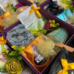 A closer look at the individual wedding favor boxes for female guests. Each box contains a beautiful scarf, Hershey's Kisses, a green tea bag, and other small, thoughtful items.
