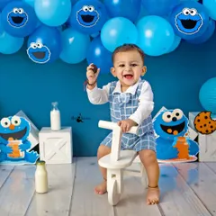 A happy boy on his tricycle, holding a cookie. This portrait captures his playful energy and the excitement of his birthday celebration.
