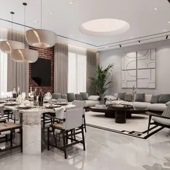 The dining area in this residence features a substantial marble-top table that seats ten, positioned under contemporary pendant lights. The design is complemented by an exposed brick wall and large art pieces, creating a stylish setting for shared meals.