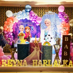 A magical Frozen 2 birthday party for Reyna Harlalka. The decor includes a beautiful backdrop of Elsa and Anna, character standees, and a pastel balloon arch with shimmering details.