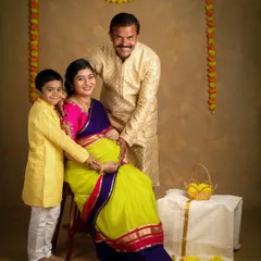 Celebrating tradition and new life. This family chose a beautiful ethnic theme for their maternity shoot, with the older brother lovingly touching his mother's baby bump.