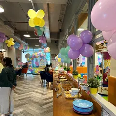 This is the view from our cafe during a Peppa Pig party. Parents can comfortably sit, eat, and chat while keeping an eye on the kids playing just a few feet away.