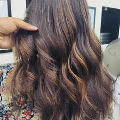 A gorgeous caramel balayage on a dark base. The hand-painted technique ensures the highlights are perfectly placed to complement the client's natural hair and add warmth.