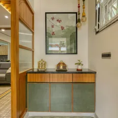The foyer at Villa 17, featuring a custom console with green shutters and a black stone top, set on our handmade cement tiles.