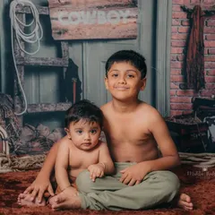 Another adorable shot of the two brothers, showing the protective and loving nature of the older sibling.