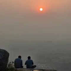There's a special peace in watching the sunrise from a hilltop. Here are two trekkers enjoying a quiet morning at Minchukallu Betta after a night of camping.