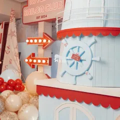Craftsmanship is at the heart of what I do. This custom-built lighthouse structure, complete with a ship's wheel and glowing marquee signage for "River's Sailor Club," shows the level of detail that makes each party a unique world.