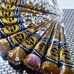 My fresh, handmade organic henna cones are ready to go. Each cone is packed with my signature paste, made from all-natural ingredients with no added chemicals, ensuring a safe application and a beautiful, dark stain.