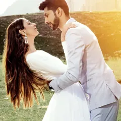 A sun-flared, romantic moment in a meadow in Kashmir. The golden light adds a warm, dreamy quality to this beautiful couple's portrait.