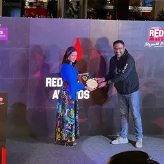 On stage receiving the Red Shakti Award. This award recognizes successful women entrepreneurs who are making a change, and I'm so proud to be honored for my work in the sports community.