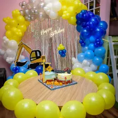 One of my favorite themes, the construction site! This party setup includes a full balloon arch in yellow, blue, and white, with a large excavator cutout ready to dig in.