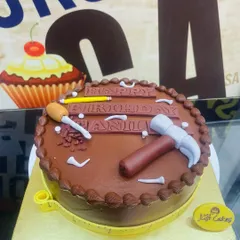 A 1.5kg chocolate cake with simple fondant tool decorations, perfect for a handyman or builder.