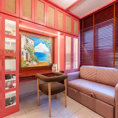 This multifunctional guest room features a hand-painted mural of a coastal village, turning a simple wall into a window to another world. The artwork serves as the focal point for the built-in desk area, making work feel like a mini escape.