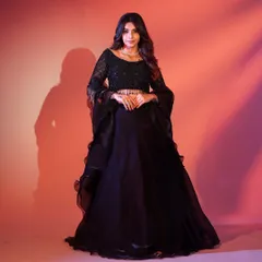 You can never go wrong with a classic black lehenga. This one features a sequined blouse and flared sleeves for a touch of modern drama, perfect for an evening reception.