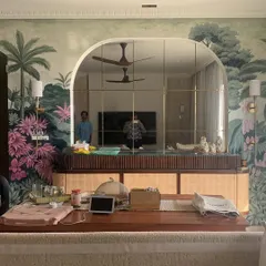 A wall mural can completely redefine a room. This wide view shows the scale of our nature mural, demonstrating how it integrates with the arched mirror and furniture to create a fully immersive, artistic atmosphere.