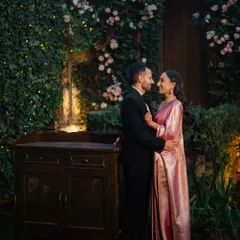 A sweet, candid moment of the couple sharing a look of love amidst the beautiful decor of their reception.