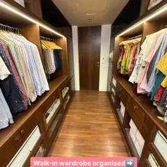 A long walk-in closet organized to create a gallery-like experience. By creating distinct zones on either side, we make the space feel both expansive and intuitive to navigate.