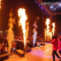 We bring full-scale concert production to life. Here, artist Diljit Dosanjh performs on stage, flanked by powerful jets of fire, showcasing the professional pyrotechnics we can arrange.