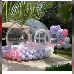 Our bubble house is a magical attraction for any outdoor party. Filled with balloons, it creates a unique photo opportunity and a whimsical play space for kids and adults alike, shown here at a garden party.