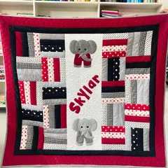 We create personalized quilts perfect for celebrating a new arrival. This adorable baby quilt for Skylar features custom name and elephant appliqués, all pieced and finished with durable longarm quilting to be loved for years.