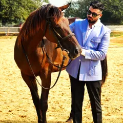 A gentleman's pursuits. Our light blue safari jacket is pictured here in a rustic setting, proving that great style is at home anywhere. The jacket's unique design makes it a versatile statement piece.