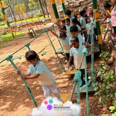Children navigate a rope bridge at Discovery Village, building courage and gross motor skills in an exciting outdoor setting.