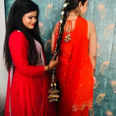 Another shot of me styling the parandi, showing the joy and personal touch I bring to helping my clients get ready.