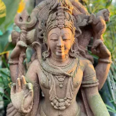 A meditative and serene Lord Shiva with his trusted Nandi, handcrafted from sandstone. This sculpture is ideal for a garden, where it can be enveloped by foliage.