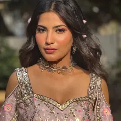 A soft, romantic look perfect for a daytime Mehendi or carnival event. I focused on creating dewy skin that glows in the sunlight, paired with a hint of pink on the eyes and lips, and whimsical flowers woven into her hair.