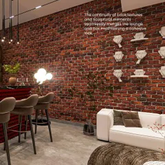 The continuity of the brick texture and sculptural elements seamlessly merges the lounge and bar areas, maintaining a cohesive look throughout the entertainment space.