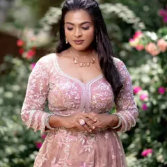 A soft and subtle look that enhances her natural dusky beauty. The makeup is minimal, allowing her elegant features and beautiful outfit to shine.