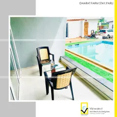A quiet seating corner overlooking the pool at Gharat Farm Stay. We design spaces that encourage relaxation and a connection with the serene natural surroundings.