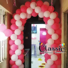 A classic pink and white balloon arch, perfect for framing a doorway and welcoming guests into the celebration.