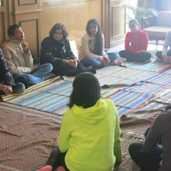 This is what my process looks like on the ground. A circle of trust, where we connect as humans first. In this intimate setting, we sit together, listen, and share, creating a space where honest stories and self-discovery can flourish without pressure or judgment.