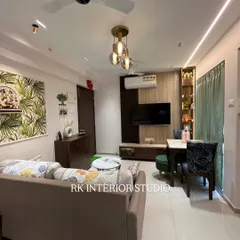This wide-angle shot shows how a living and dining area can be integrated seamlessly. Notice the tropical wallpaper adding a fresh vibe and the pendant lights defining the dining space.