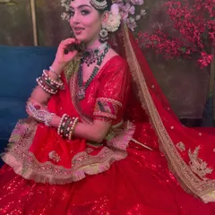 This image captures the complete look, from the floral hair accessories to the sparkling lehenga. This is a perfect ensemble for a grand Nikkah or Walima ceremony.
